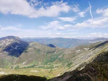 Aerial view of mountain range against cloudy sky