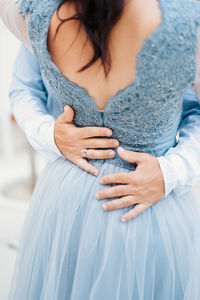 Midsection of woman with hands standing outdoors