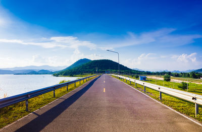 Road by mountain against sky