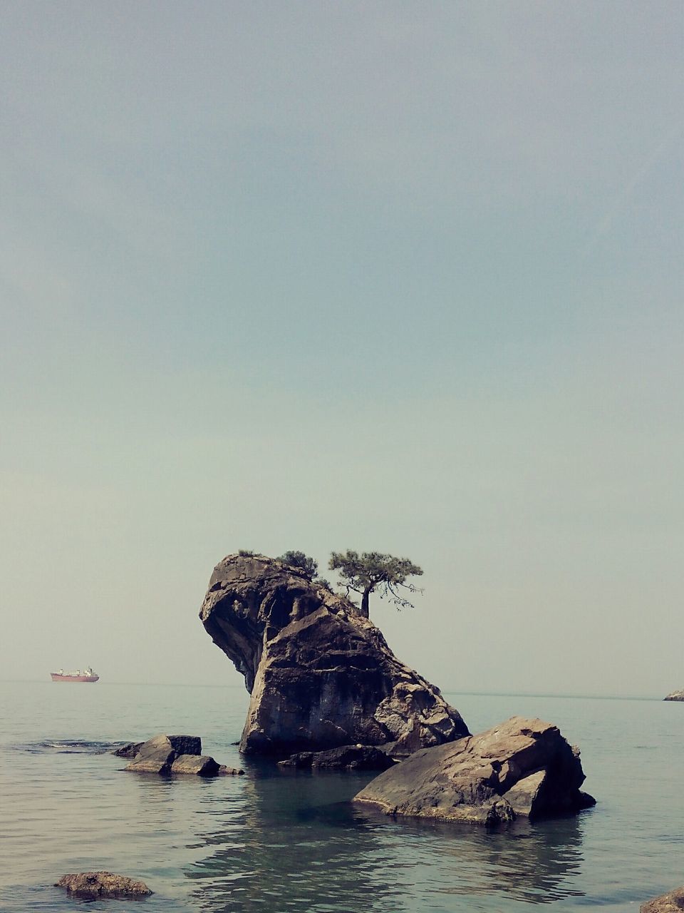 water, sea, rock - object, waterfront, nautical vessel, tranquility, scenics, tranquil scene, rock formation, horizon over water, beauty in nature, boat, nature, clear sky, transportation, sky, mode of transport, copy space, cliff, rock