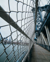 Close-up of chainlink fence on footbridge