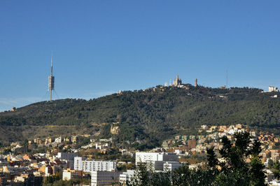 View of town against clear blue sky