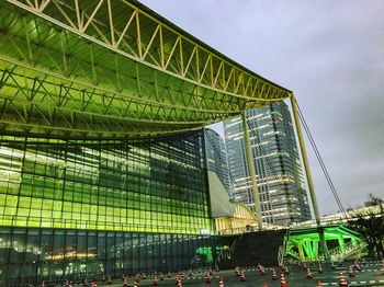 Low angle view of modern building against cloudy sky