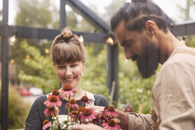 Smiling couple in greenhouse