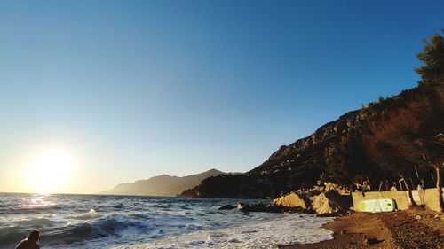 Scenic view of sea against clear blue sky