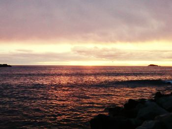 Scenic view of sea against cloudy sky