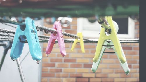 Close-up of clothespins hanging on clothesline