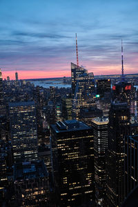 Aerial view of buildings in city during sunset