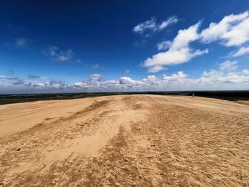 Scenic view of dune against sky