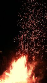 Low angle view of firework display at night