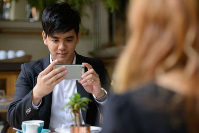 Portrait of woman using mobile phone outdoors