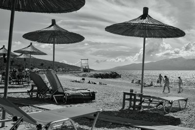 People at beach against sky