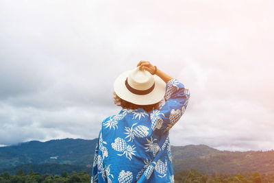 Rear view of woman wearing hat against sky