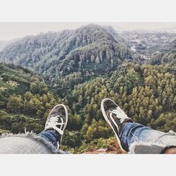 Low section of person relaxing on mountain