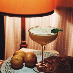 Close-up of foamy orange drink on vintage retro table