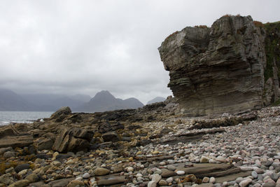 Rock formations by sea against sky