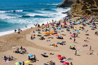 People on beach against sky