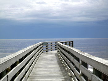 View of pier on calm blue sea