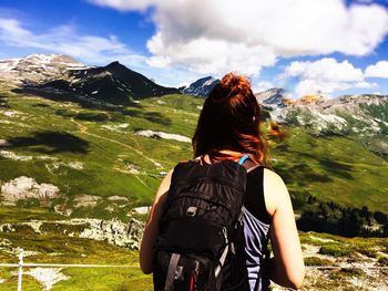Rear view of woman standing on mountain