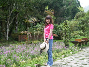 Full length of woman standing by plants