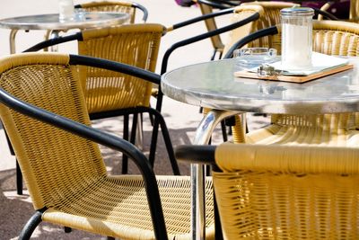 Close-up of empty chairs and tables in cafe