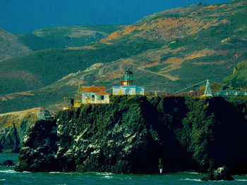 Scenic view of sea by buildings against sky