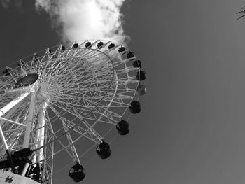 Low angle view of ferris wheel against sky