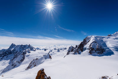 Scenic view of snow covered rock formation against sky