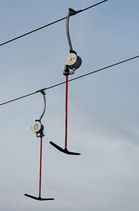 Low angle view of telephone pole against sky