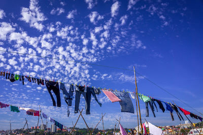 Low angle view of clothes drying against sky