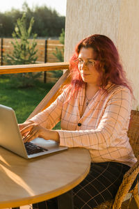 Young woman using laptop at table