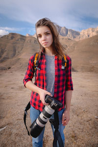 Beautiful young woman standing on land