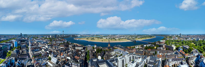 High angle view of crowd by buildings against sky