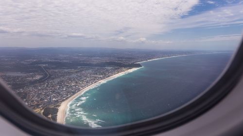 Aerial view of cityscape seen through airplane window
