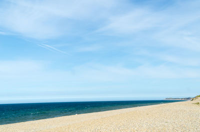 Scenic view of beach against blue sky