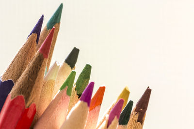 Close-up of colored pencils against white background