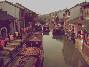 Panoramic view of canal amidst buildings against sky