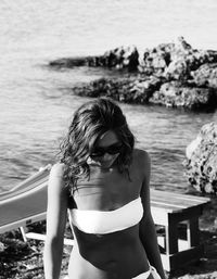 Young woman in bikini standing at beach