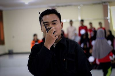 Portrait of young man standing at home