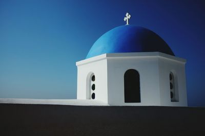 Low angle view of bell tower against blue sky