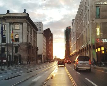 Cars on road in city against sky