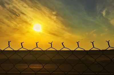 Sunset seen through chainlink fence