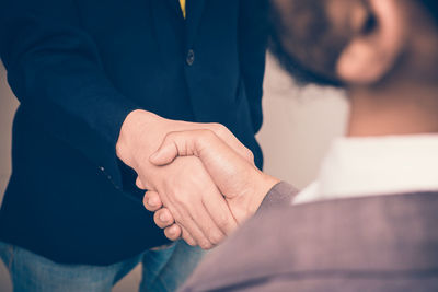 Midsection of business colleagues shaking hands