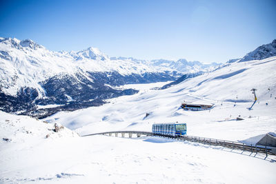 Cable car carrying skiers up the mountain at st moritz switzerland. 