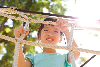 Portrait of smiling girl holding rope