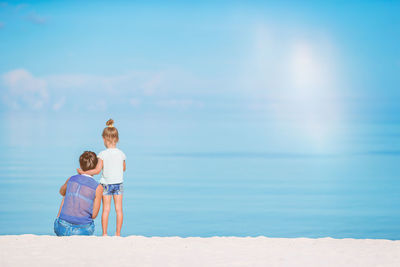 Full length of boy on beach against sky