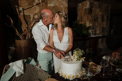 Midsection of man and woman standing on table