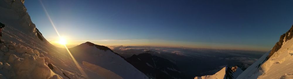 Panoramic view of snowcapped mountains against sky during sunset