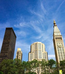 Low angle view of modern building against blue sky