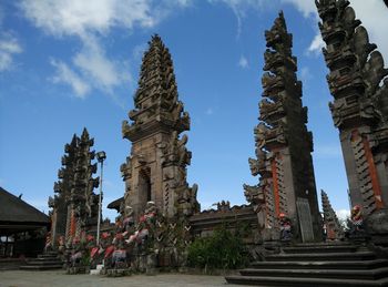 Low angle view of temple against cloudy sky